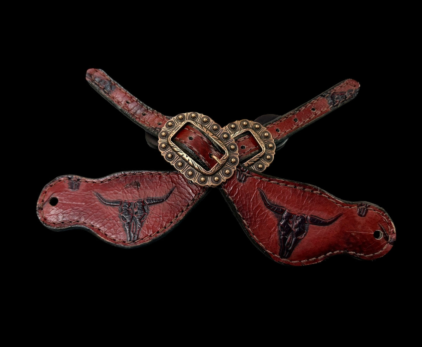 Red longhorns on dark leather