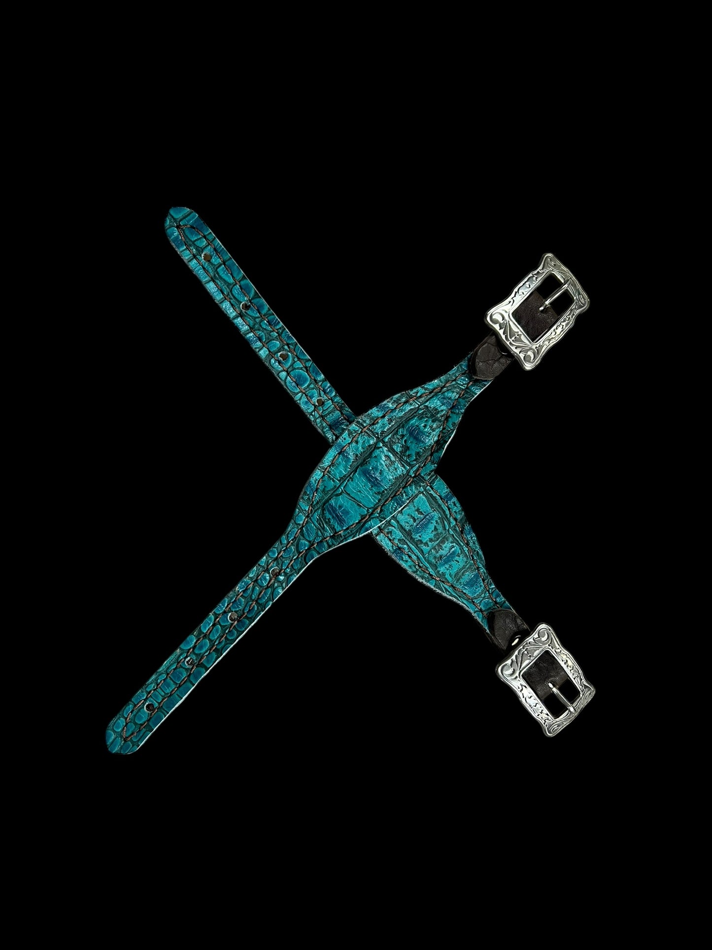 Teal gator on dark leather