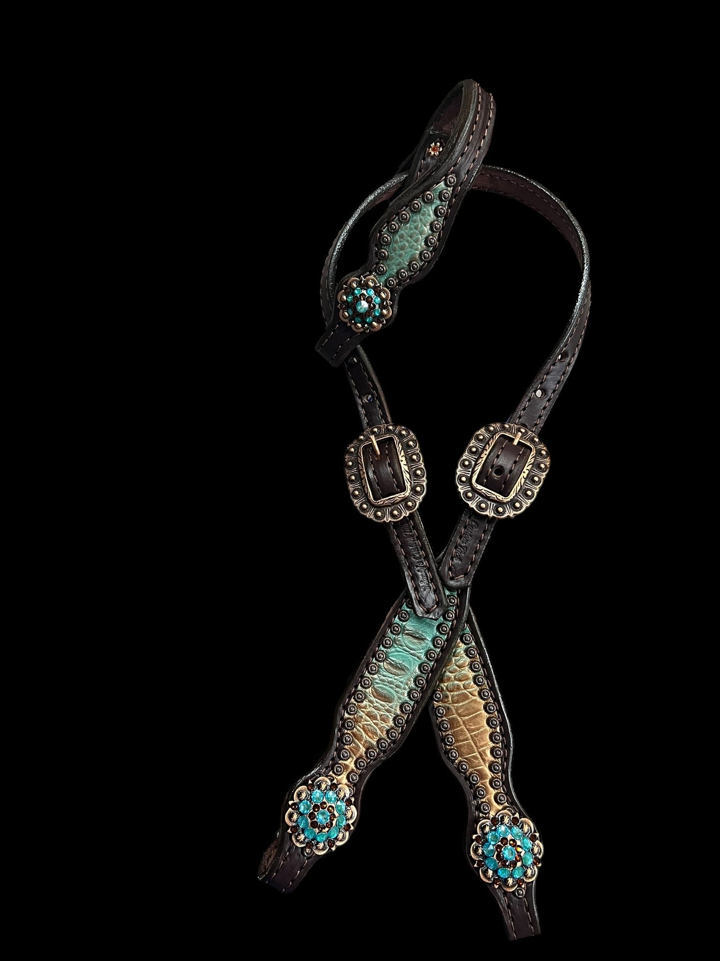 Brown and teal gator on dark leather