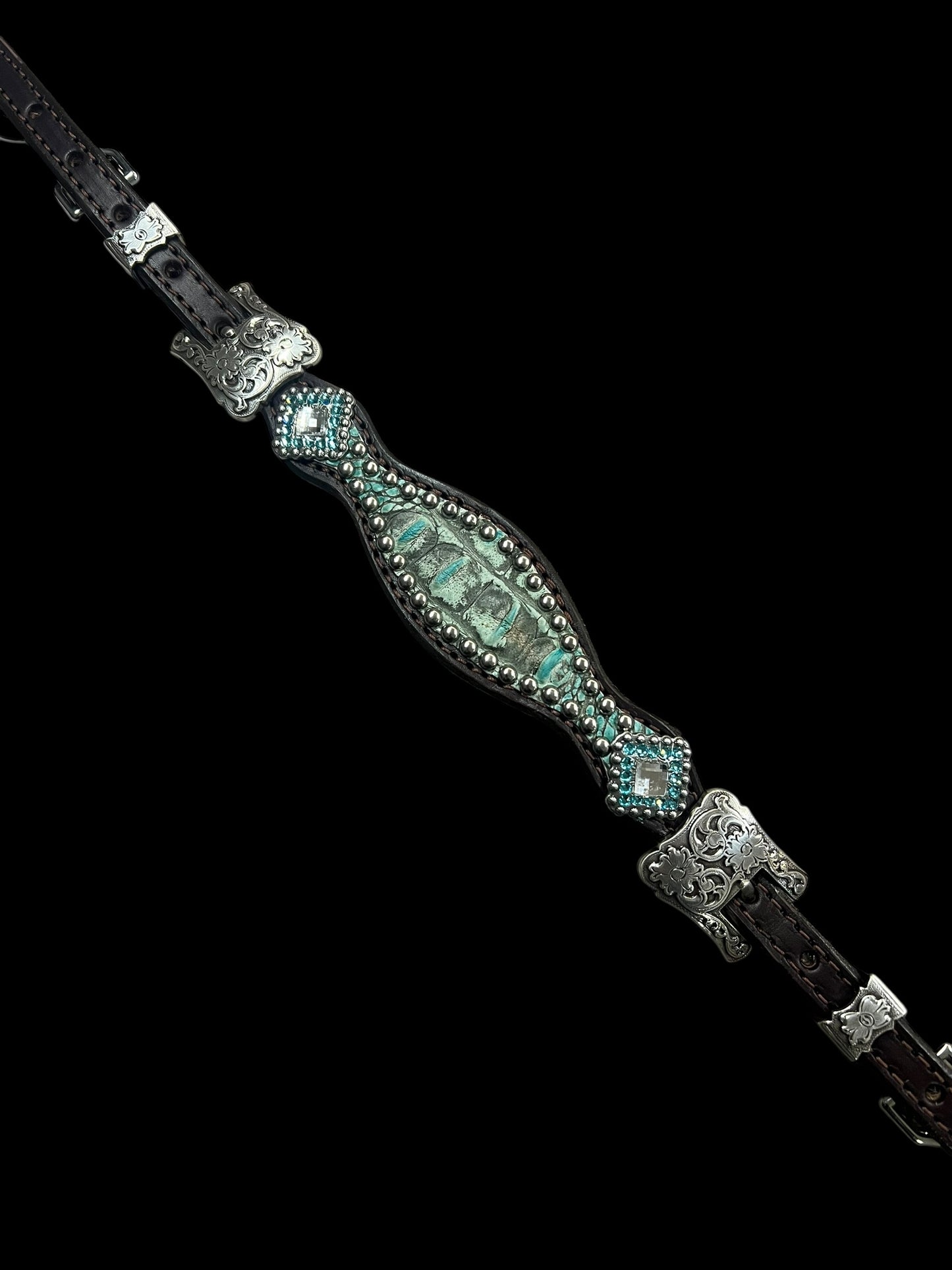 Antique turquoise gator on dark leather