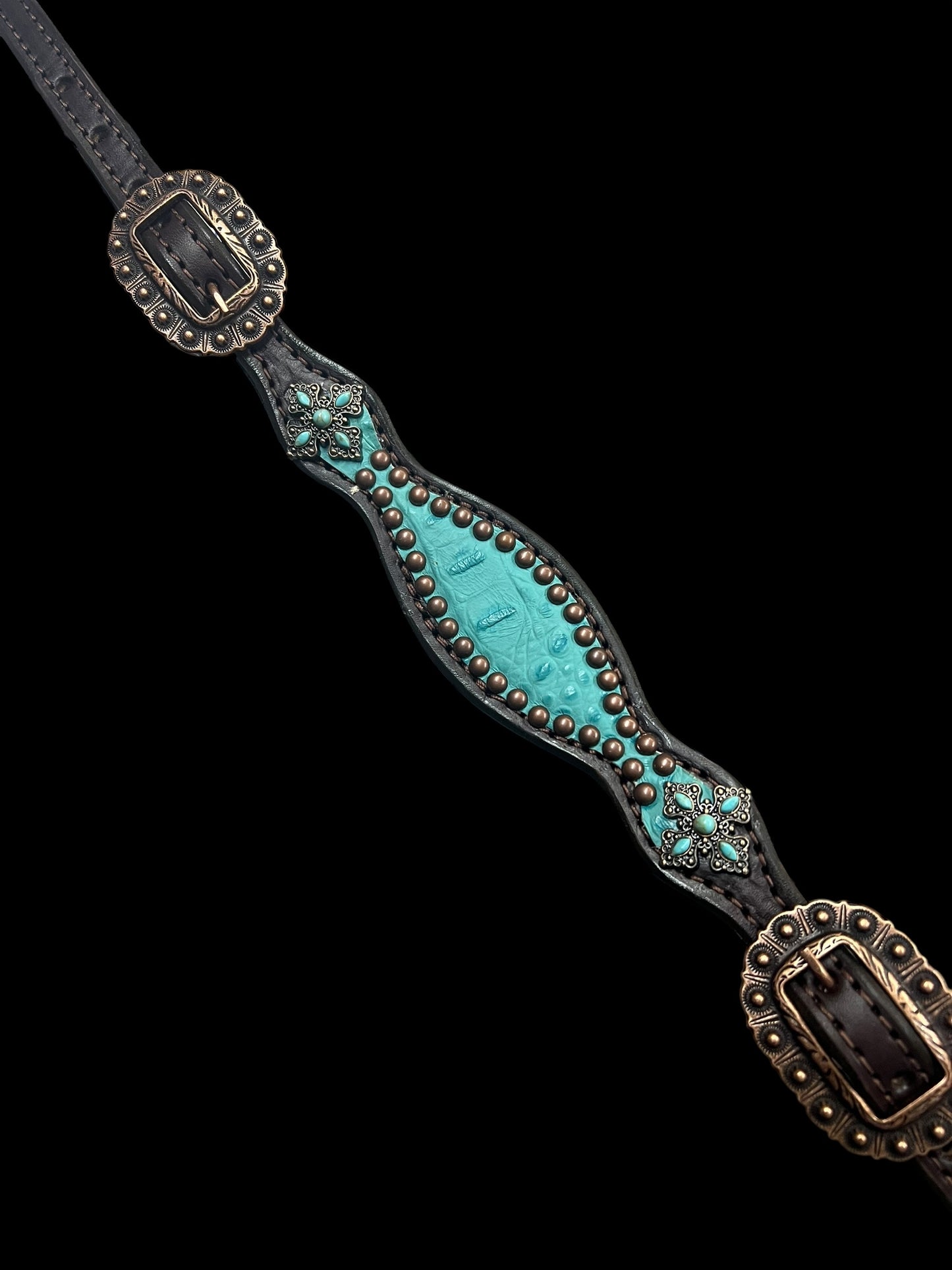 Turquoise gator on dark leather