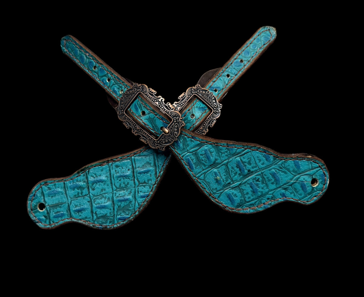 Teal gator on dark leather