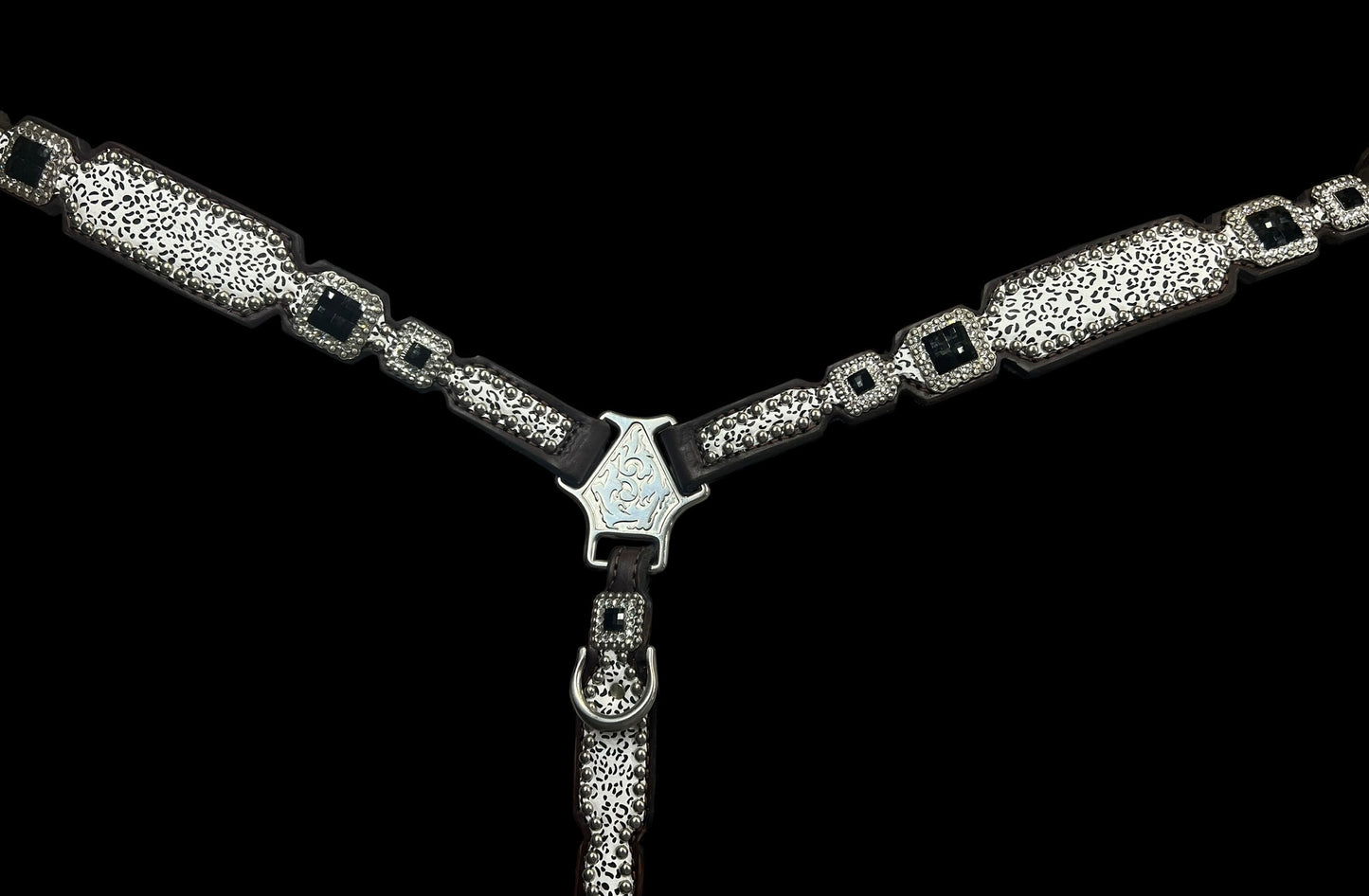 Snow leopard on dark leather