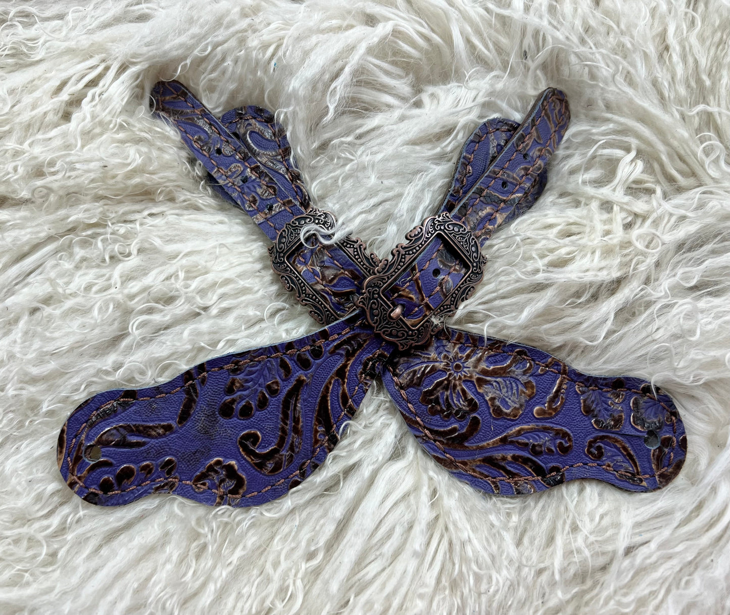 Purple and brown cowboy tool on chocolate leather