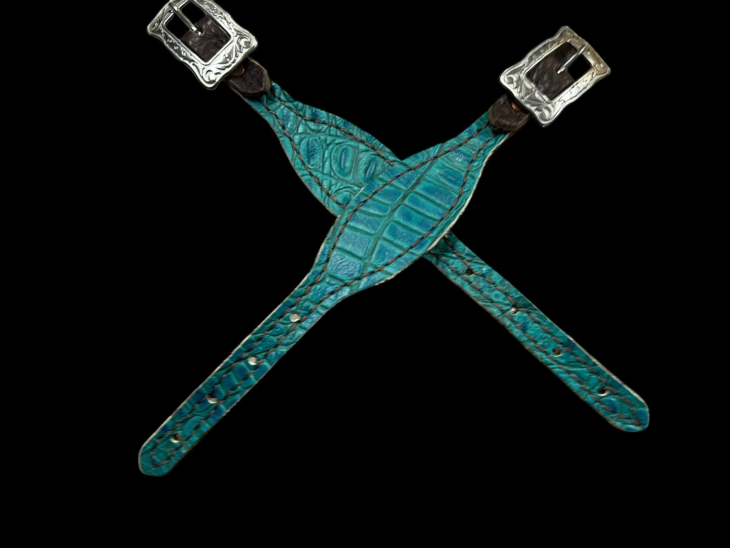 Teal gator on dark leather