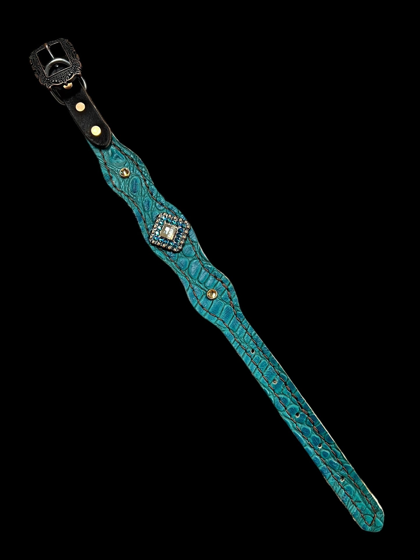 Teal gator on dark leather