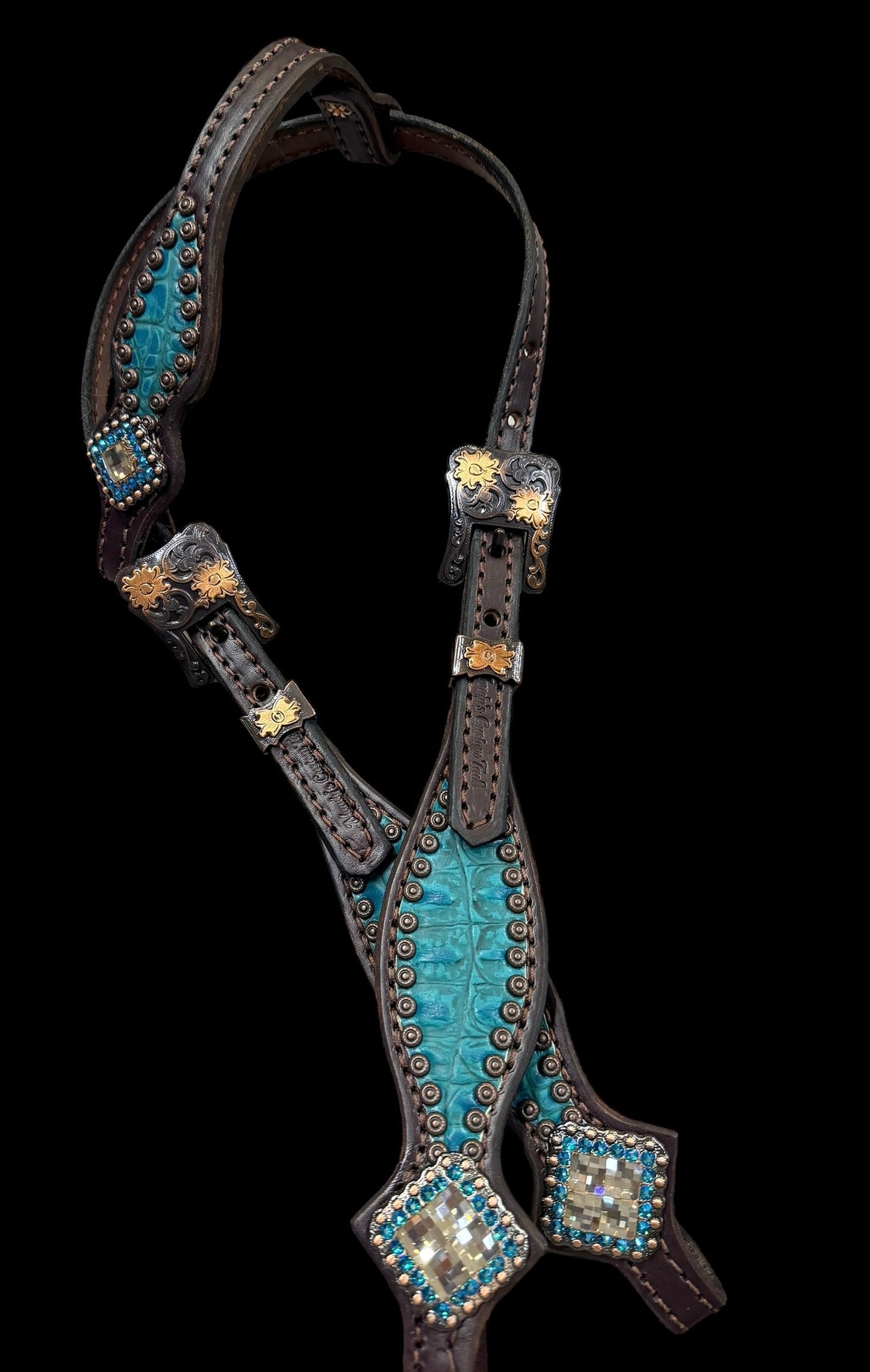Teal gator on dark leather