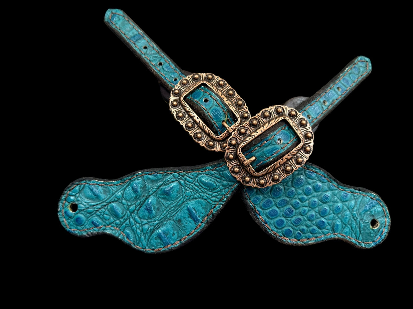 Teal gator on dark leather