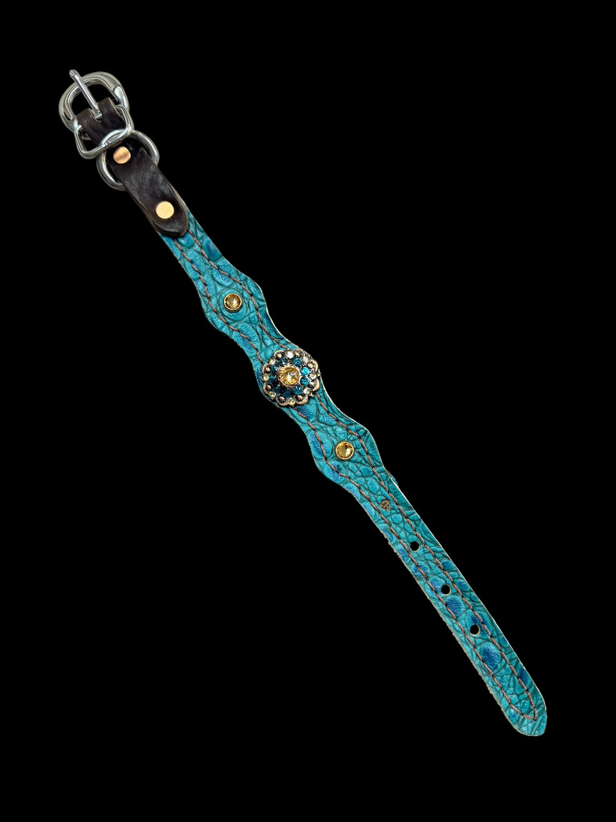 Teal gator on dark leather