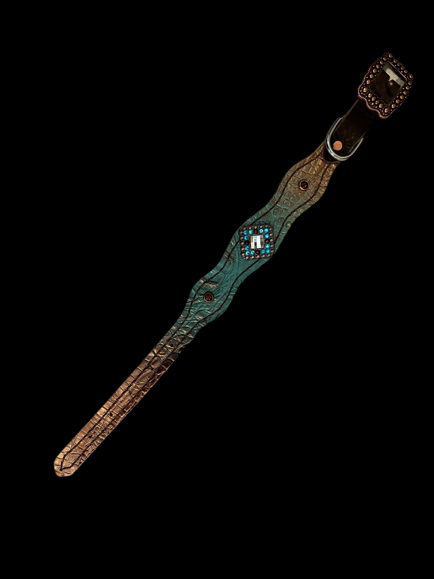 Brown and teal gator on dark leather