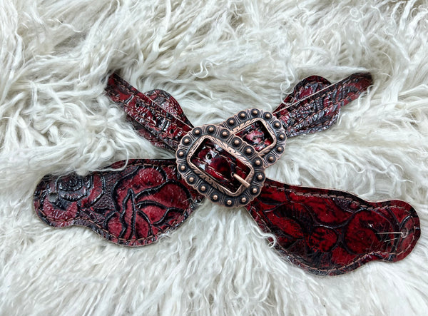 Red roses on dark leather