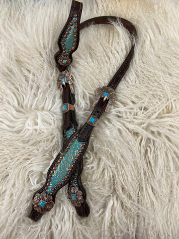 turquoise and rose gold floral on dark leather