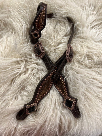 Copper snake on dark leather